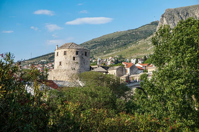 Panoramic view of trees and buildings against sky