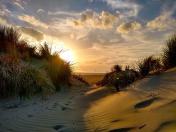 Scenic view of beach against sky during sunset