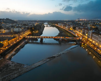 High angle view of illuminated bridge over river against sky at night