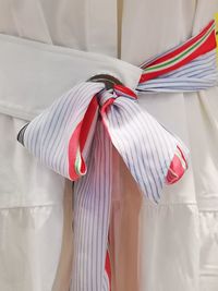 Close-up of clothes hanging on white fabric