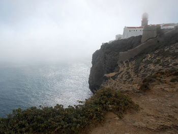 Scenic view of sea and buildings against sky