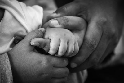 Close-up of baby holding hands