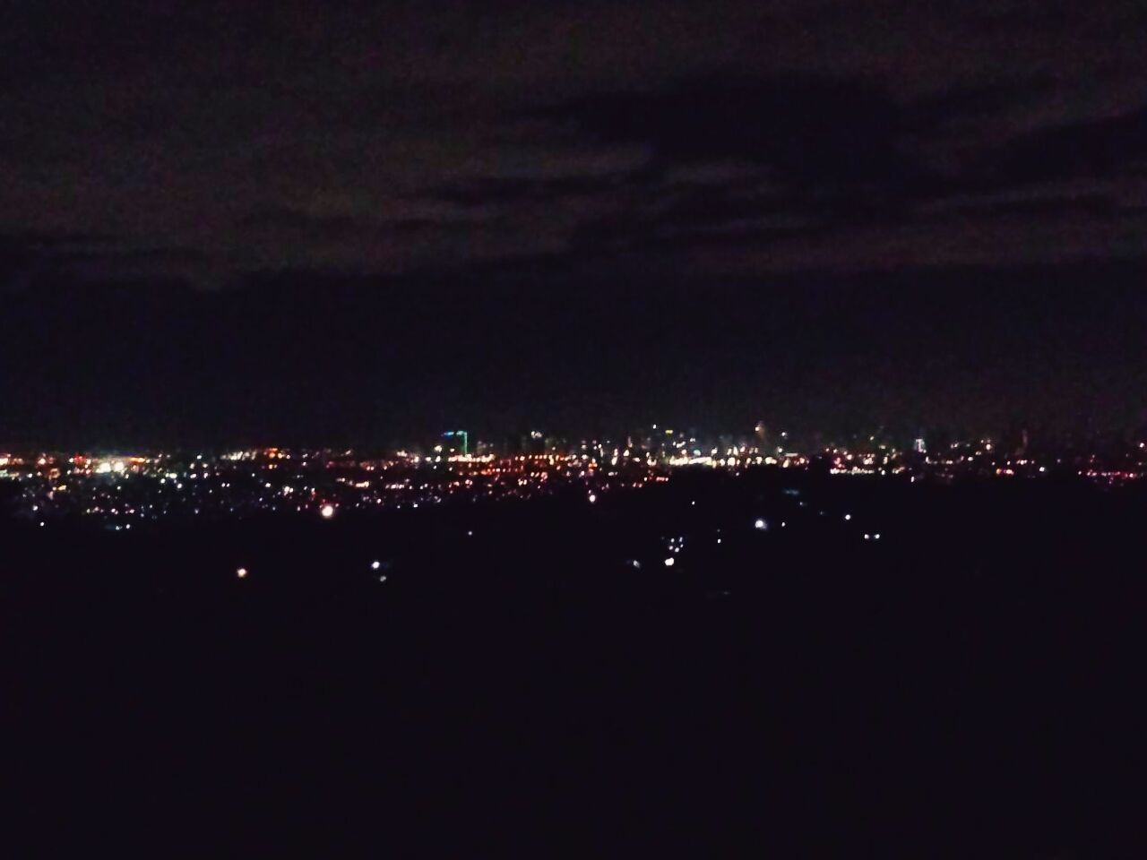 illuminated, night, cityscape, city, building exterior, sky, built structure, architecture, dark, crowded, residential district, residential building, high angle view, scenics, copy space, residential structure, dusk, cloud - sky, outdoors, landscape