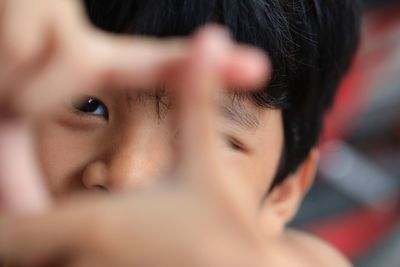 Close-up portrait of boy gesturing