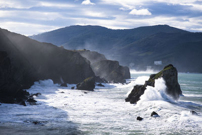 Scenic view of sea against mountains