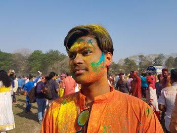 Portrait of young man against multi colored sky