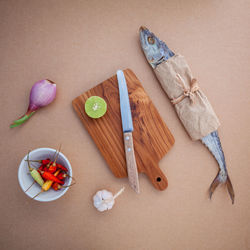 Close-up high angle view of knife and ingredient on table