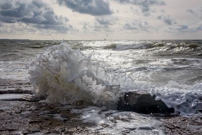 Scenic view of sea against cloudy sky