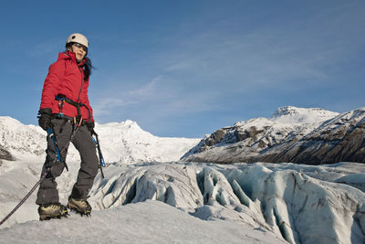 Woman climbing on the fjallsjökull glacier in iceland