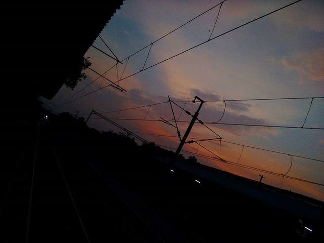 power line, electricity pylon, electricity, sky, transportation, cable, power supply, connection, sunset, silhouette, railroad track, cloud - sky, fuel and power generation, rail transportation, power cable, low angle view, technology, dusk, built structure, no people