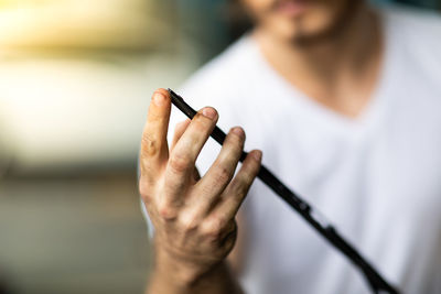 Midsection of woman holding cigarette