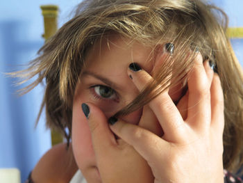 Close-up portrait of girl covering eye