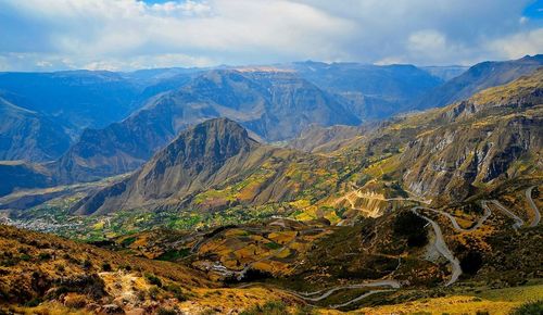 Scenic view of mountains against cloudy sky