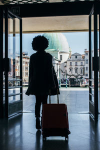 Rear view of silhouette man walking in airport