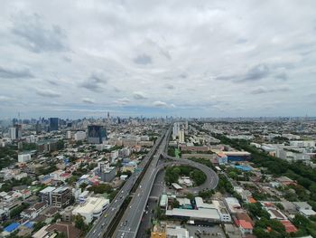 High angle view of city street and buildings against sky