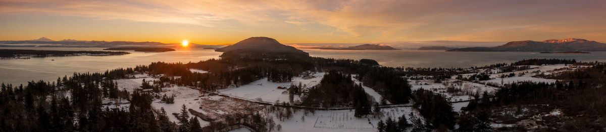 Sunrise in the salish sea. a rare snowfall blanket lummi island, washington.