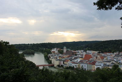 High angle view of townscape by river against sky