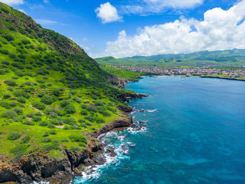 High angle view of sea and mountains against sky