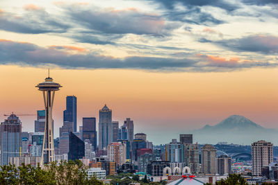 View of cityscape against cloudy sky