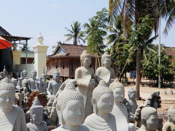 Panoramic shot of buddha statues outside building at a stone cutting yard in kampong cham, cambodia. 