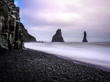 Scenic view of sea against cloudy sky