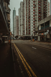 View of city street and buildings against sky