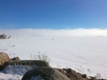 Scenic view of snow covered land against sky
