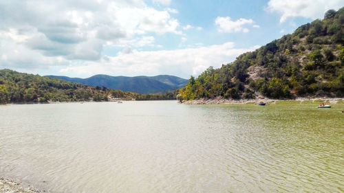 Scenic view of lake and mountains against sky