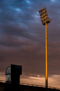 Low angle view of communications tower against dramatic sky