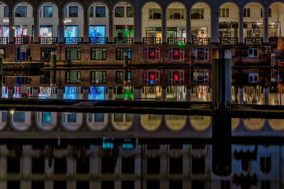 Reflection of illuminated building on calm lake