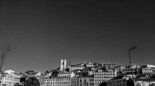 Buildings in city against clear sky