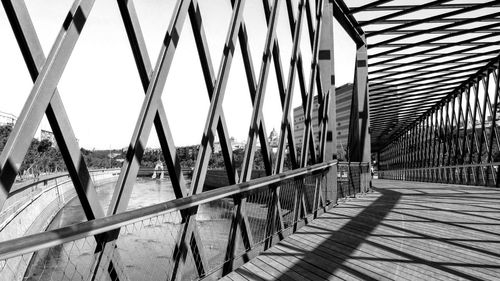 Metal railing on footpath amidst buildings