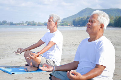 Senior men exercising at beach