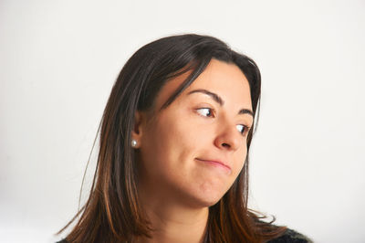 Close-up of young woman against white background