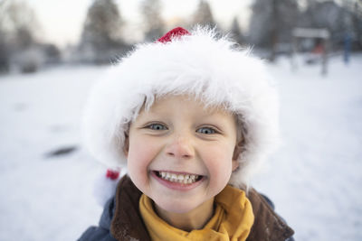 Happy cute boy wearing santa hat