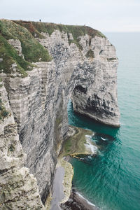 Rock formations by sea against sky