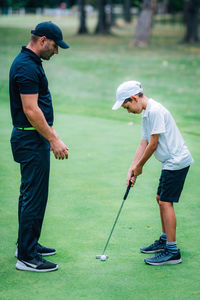 Full length of man playing golf course