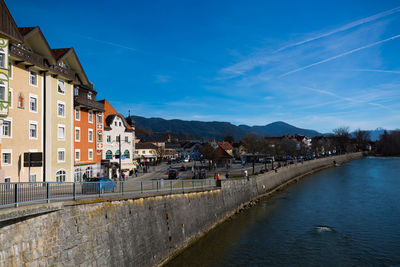 Canal amidst buildings in town against sky