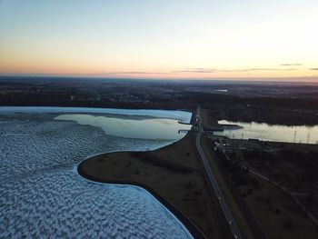 Aerial view of sea against sky during sunset