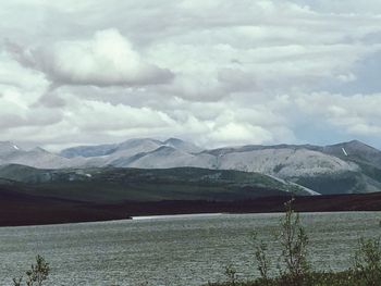 Scenic view of lake and mountains against sky