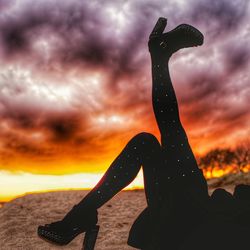 Silhouette woman sculpture against sea during sunset