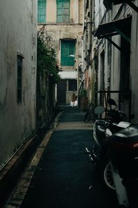 Empty alley amidst buildings in city