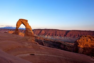 Rock formations on landscape against clear sky