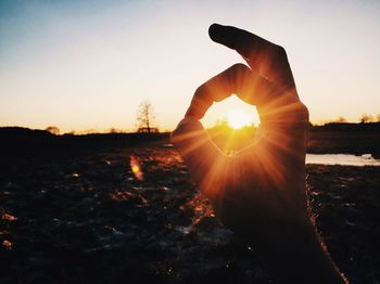 Sun shining on field during sunset