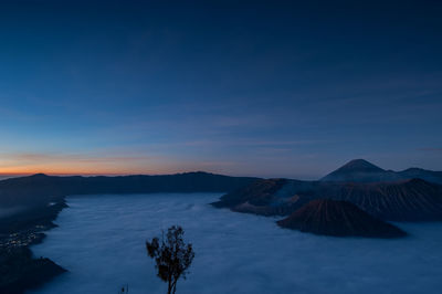 View of volcanic mountain against cloudy sky