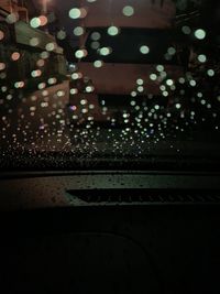 Close-up of illuminated lights on wet floor