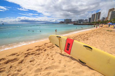 Surfboard on sandy beach