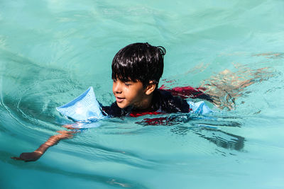 Portrait of young woman in water