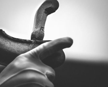 Close-up of human hand holding metal