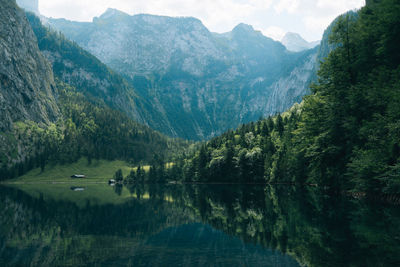 Scenic view of lake and mountains against sky